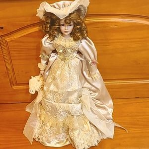 Vintage Porcelain Doll in a Maxi Detailed and Handmade Golden Dress.